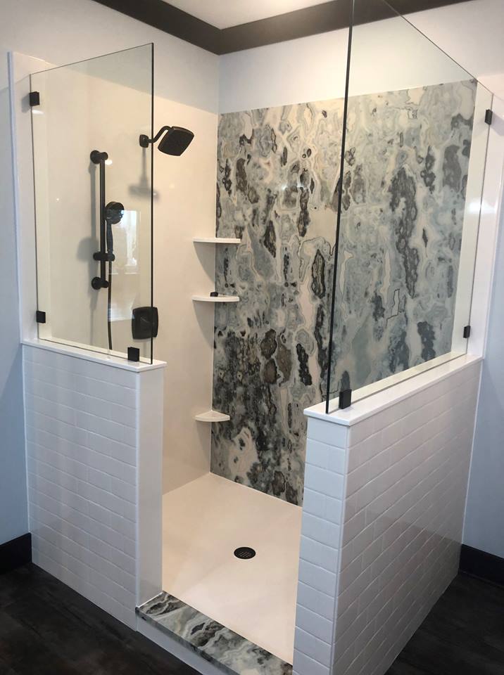 Grout free Subway Tile Shower with Tyvarian accent wall , shower threshold, Features solid surface walls and niches, shower floor and glass enclosure. All from AMI, American Marble Industries, Canton, OH.
