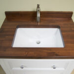 Madera Cherry Vanity Top with white undermount sink and cabinet. Bathrooms by AMI.