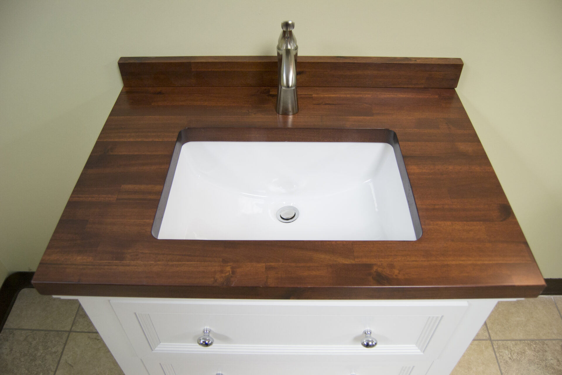 Madera Cherry Vanity Top with white undermount sink and cabinet. Bathrooms by AMI.