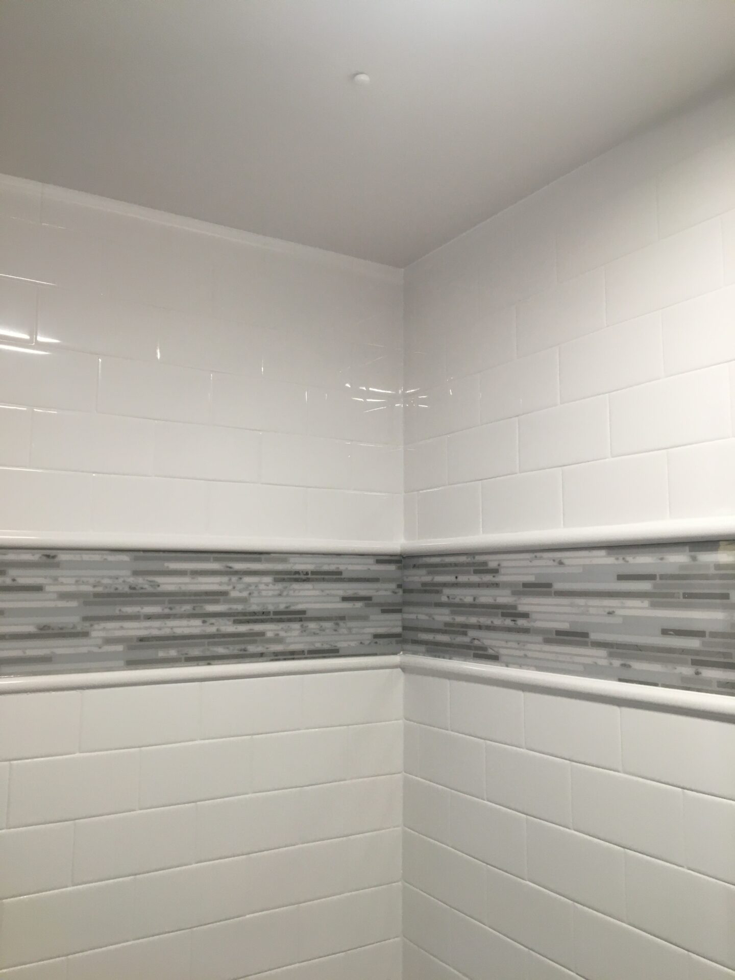 Subway bathroom shower wall tile with Tyvarian inlay available from AMI in Canton, Ohio.