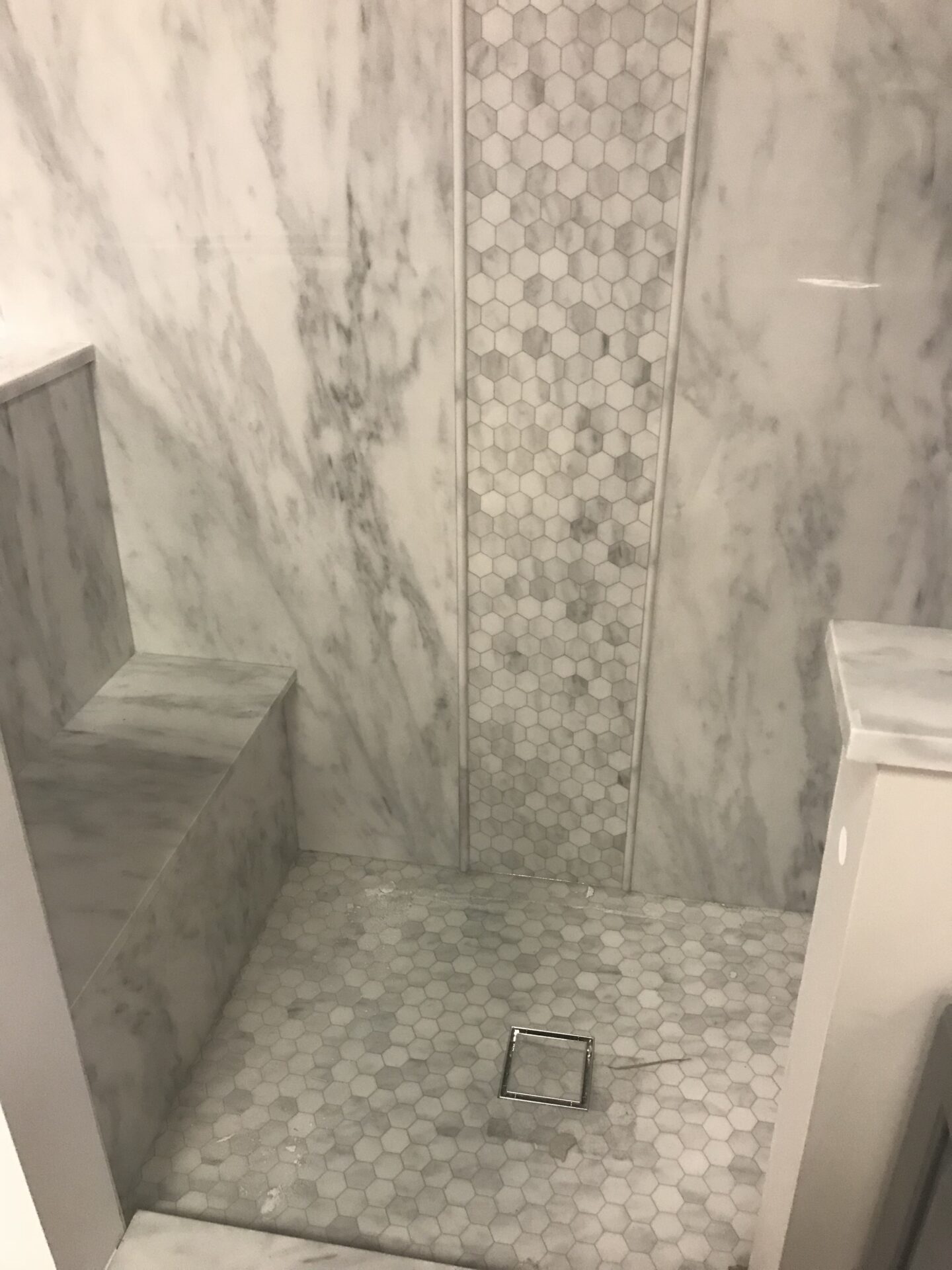 Shower features TYVARIAN Calcutta Gray with Inlay and Floor of Grout Free tile alternative. AMI in Canton, OHIO