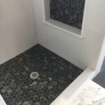 TYVARIAN OBSIDIAN base and Inlay. Solid surface shower is Grout Free. Contact AMI in Canton, Ohio.