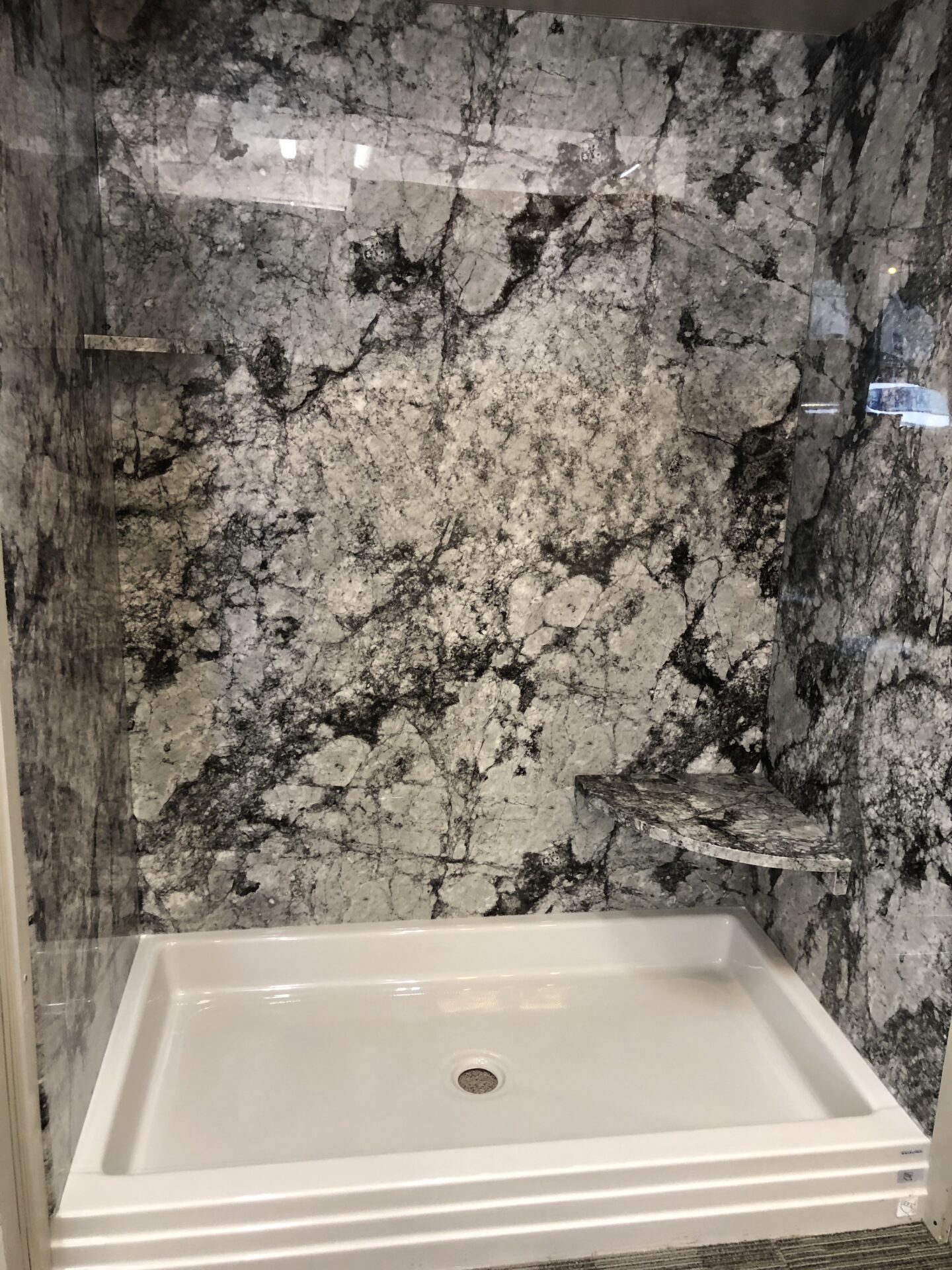 Tyvarian Lunar Shower with solid surface shower base. You can customize your bath with tile alternatives that are grout free = no leak, no scrubbing. Contact AMI in Canton, Ohio.
