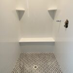 Tyvarian Polaris Shower Floor with solid surface shower walls. Contact AMI in Canton, Ohio.