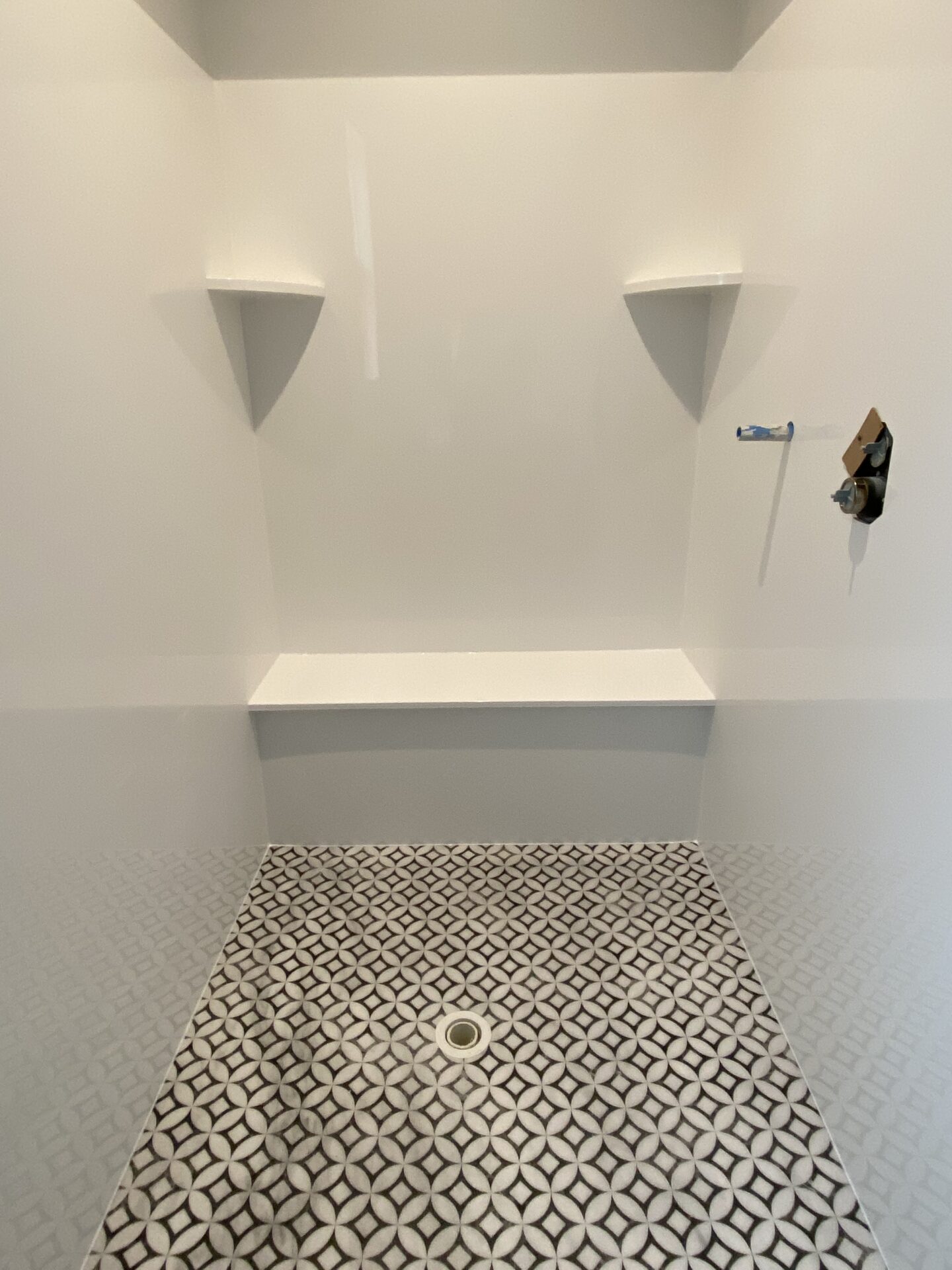 Tyvarian Polaris Shower Floor with solid surface shower walls. Contact AMI in Canton, Ohio.